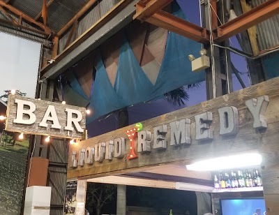 The lit Liquid Remedy Bar sign