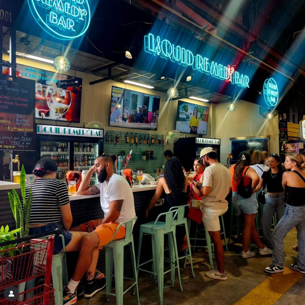 Guests gathered at Liquid Remedy Bar inside Yellow Green Farmers Market